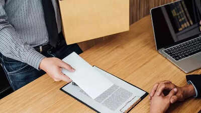 A professional checks their phone anxiously as job notifications flash immediate joiner required sym.jpeg