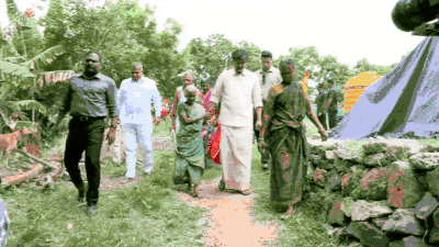 Cm vijay gifts sunglasses to an elderly woman.jpg